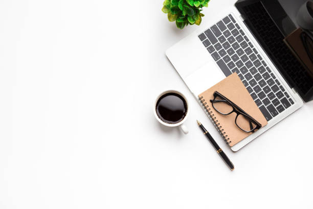 istock Flat lay, top view office table desk. Workspace with, laptop,office supplies, pencil, green leaf, and coffee cup on white background. 1300657925