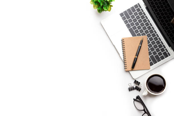 istock Flat lay, top view office table desk. Workspace with, laptop,office supplies, pencil, green leaf, and coffee cup on white background. 1300657927
