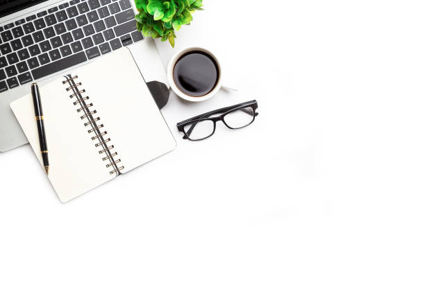 istock Flat lay, top view office table desk. Workspace with, laptop,office supplies, pencil, green leaf, and coffee cup on white background. 1300657933