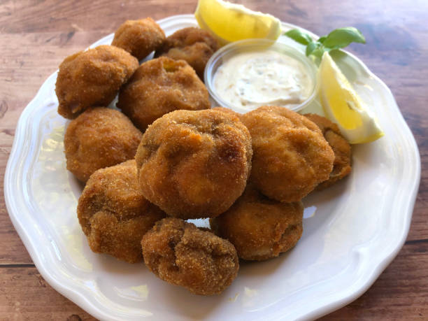 istock Crispy, deep fried, breaded mushrooms with sauce tartar. 1300660024
