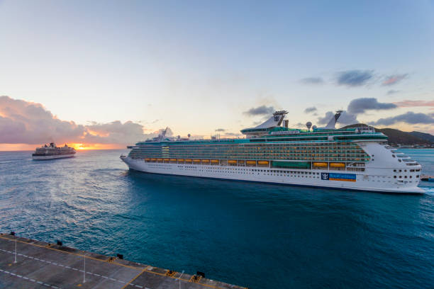 Cruise ships leaving Philipsburg Port, St. Maarten Philipsburg, St Maarten, - February 01, 2013: Royal Caribbean cruise ship Freedom of the Seas leaving port in Philipsburg, Sint Maarten, Dutch Caribbean at sunset. saint martin caribbean stock pictures, royalty-free photos & images