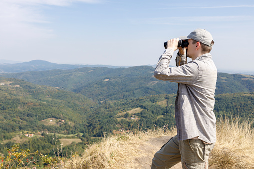 Man using binoculars outdoors