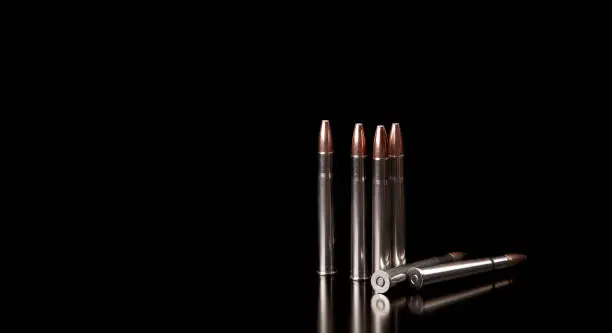 Bullet isolated on black background with reflexion. Rifle bullets close-up on black back. Cartridges for rifle and carbine on a black.