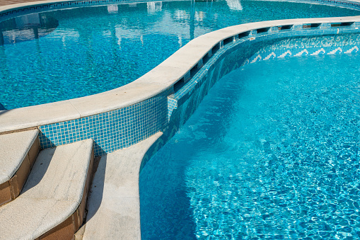 Traditional design swimming pool for tourists at the hotel. Against the backdrop of the bright sun