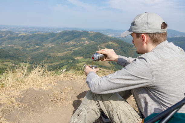 istock Adventurist drinking coffee during hiking rest 1300663846
