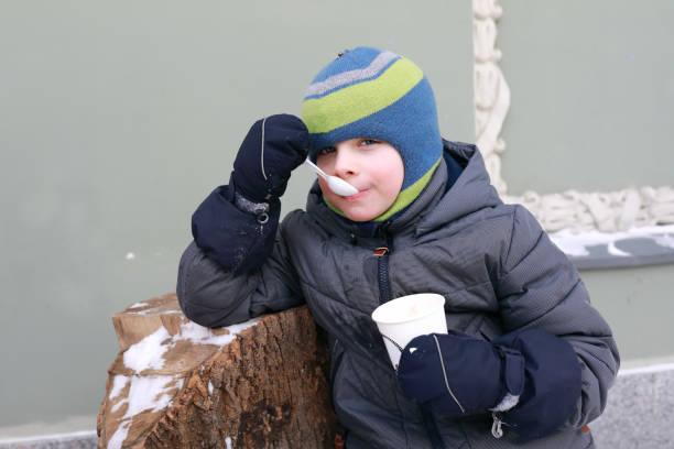 istock Child eating ice cream in winter 1300664389