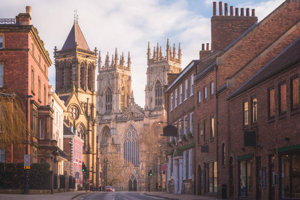 York Old Town, England Morning golden light on the historic old town of York along Museum St. looking towards York Minster Cathedral. north yorkshire photos stock pictures, royalty-free photos & images