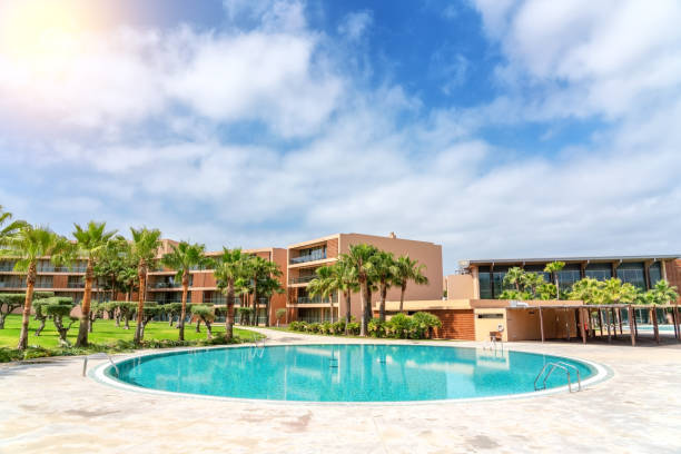 istock Modern luxurious pool with clean, clear, blue water, palm trees 1300664972