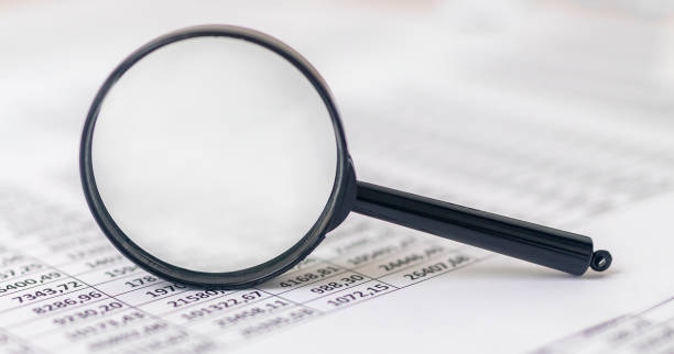 istock The magnifier and documents with financial economical digits 1300667745