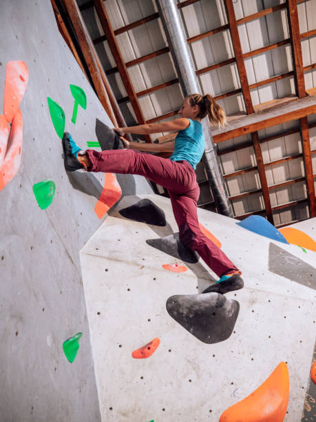 istock Woman indoor climbing in boulder gym 1300669455