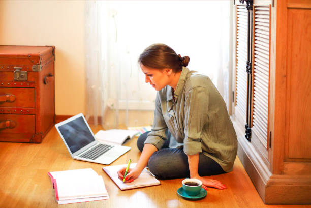 istock Woman designer using laptop on floor 1300669569