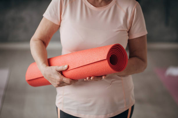 istock Woman holding exercise mat for yoga class 1300670914