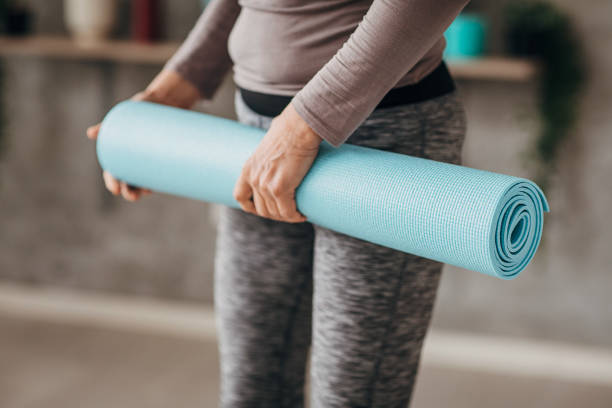 istock Woman holding exercise mat for yoga class 1300670930
