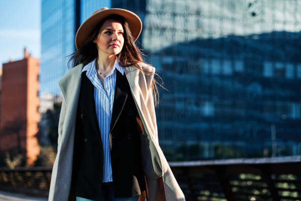 istock Stylish woman standing outdoors on a bridge. 1300671749