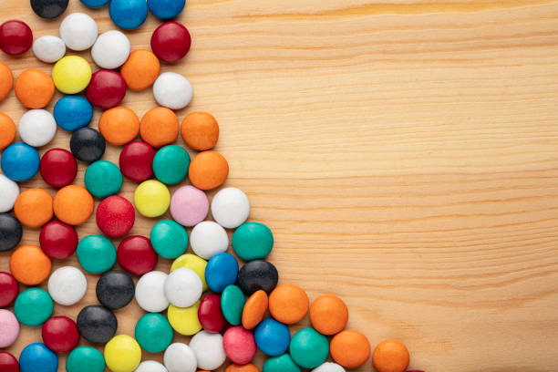 istock Colorful chocolate candy stones on white background 1300671890