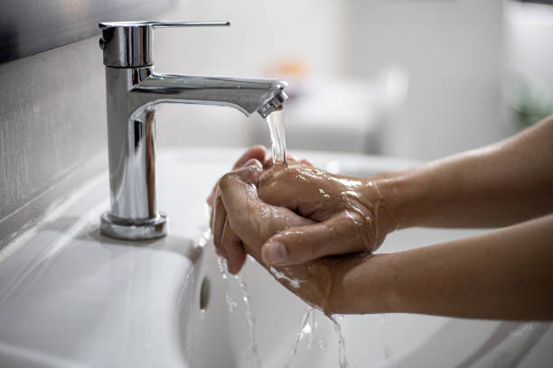 istock People washing their hands in the sink 1300672094