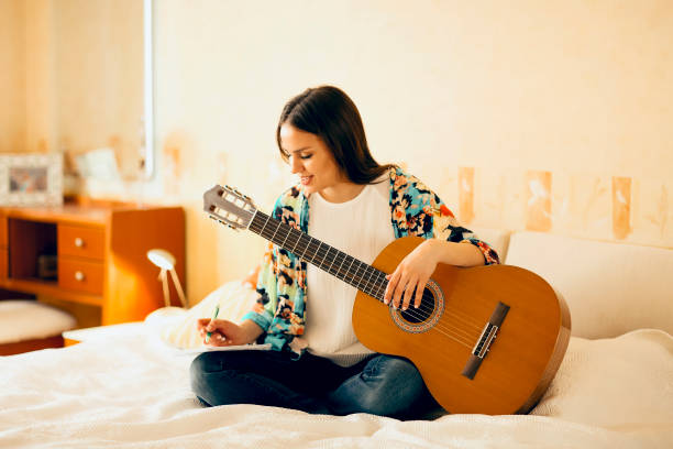 istock Woman writing song on bed 1300672847