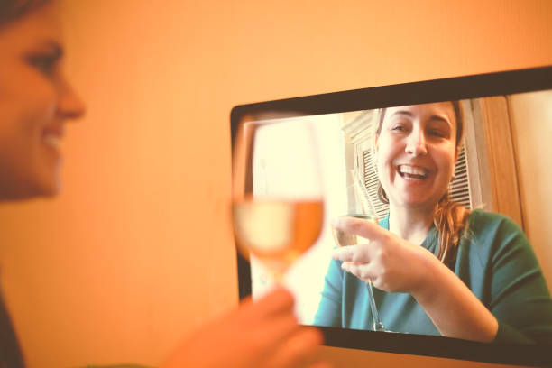 istock Cheerful women drinking wine via video chat 1300672955