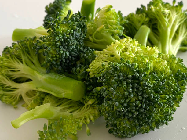 istock Close Up Broccoli Florets on White Background 1300674164