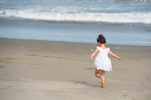 istock Girl playing at the beach 1300674624