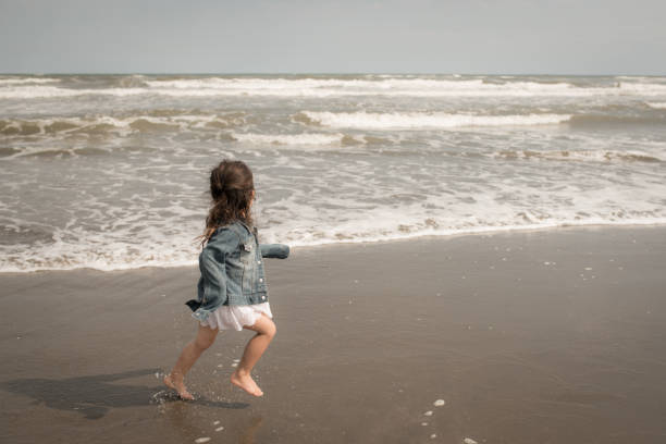 istock Girl playing at the beach 1300674629