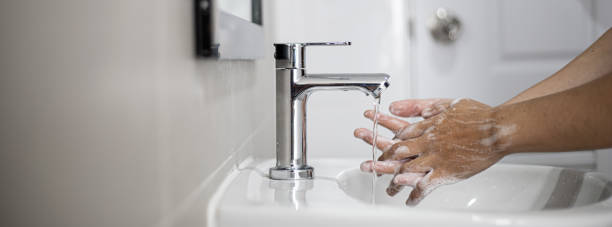 istock People washing their hands in the sink. 1300674683