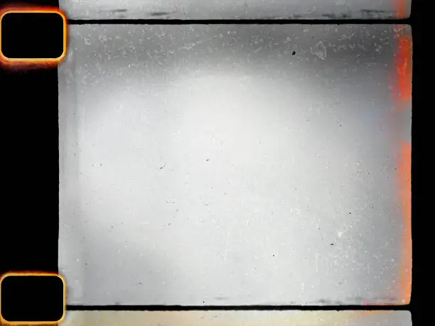 Photo of empty or blank 16mm film frame with black border and dust.