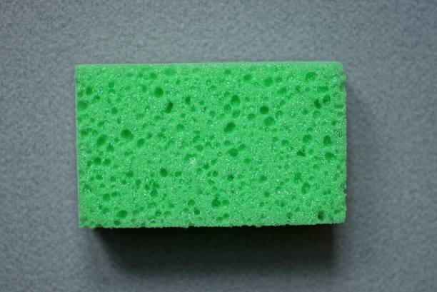 istock green foam sponge lie on a gray table 1300676884