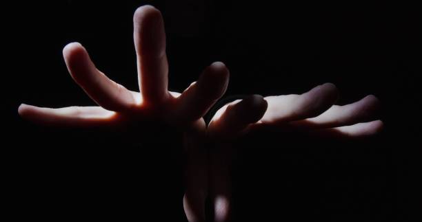 istock Pair of hands opening fists 1300682299