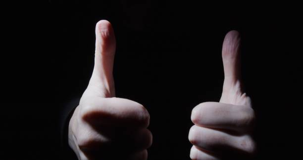 istock Pair of hands is showing thumbs up 1300682493