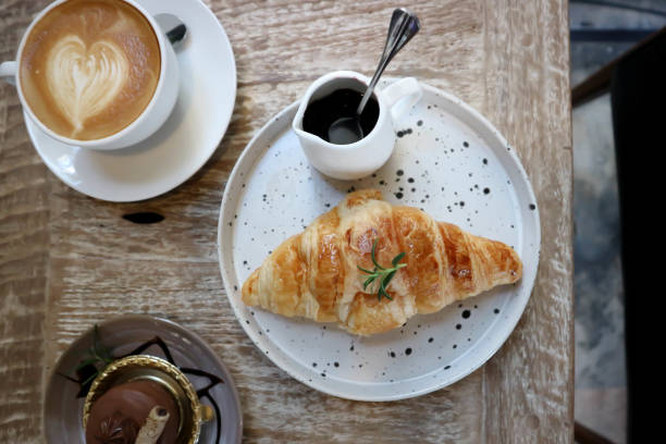 istock hot cofffee , croissant and chocolate cake 1300682495