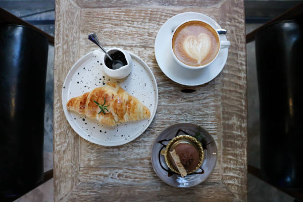 istock hot cofffee , croissant and chocolate cake 1300682497