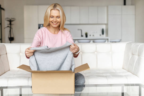 istock Middle-aged woman unpacking 1300683798