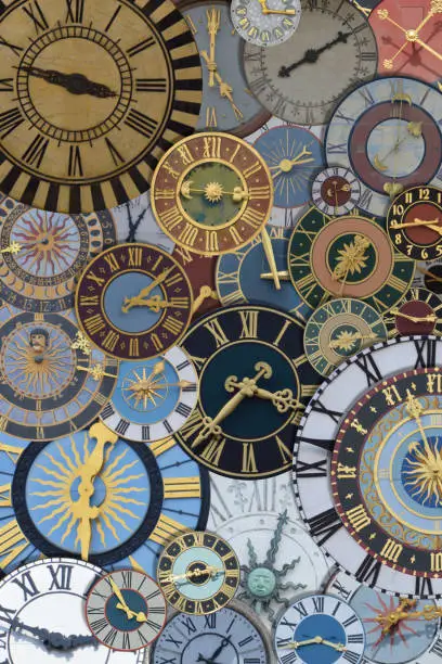 Photo of multicolored collection of ancient church tower clocks on a pile