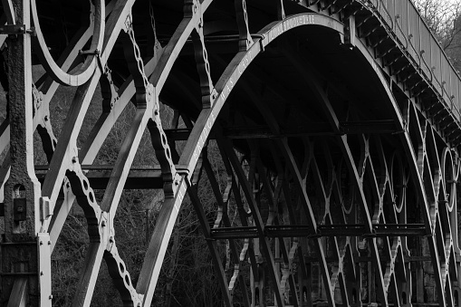 Telford, UK - February 18, 2013. The Iron Bridge historical landmark near Telford, the first cast iron arch bridge built at the start of the industrial revolution. Ironbridge Gorge, Telford, Shropshire, UK