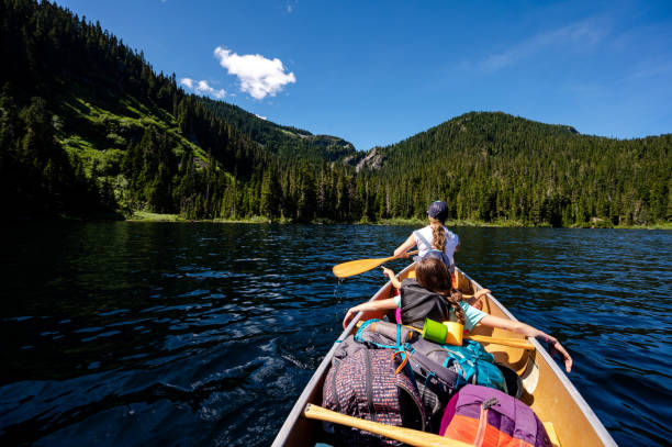 istock Family canoeing on a stunning mountain lake 1300689672
