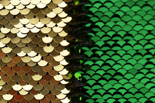 istock Sequins background Green and gold sequins half background. macro shimmer texture. shiny fabric. Glitter Material Texture 1300690279