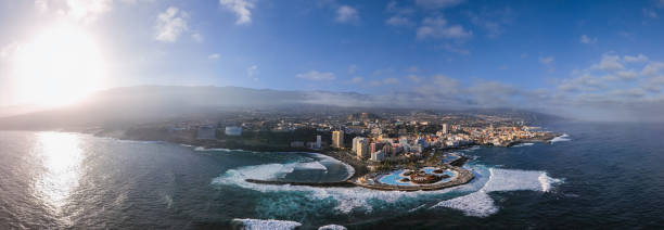 Aerial panorama of Puerto de la Cruz resorts and pools surrounded by sea waves, Tenerife, Canary islands, Spain. Aerial view of Puerto de la Cruz, Tenerife puerto de la cruz tenerife stock pictures, royalty-free photos & images