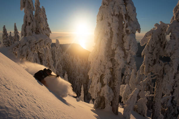 istock Backcountry skier descends through deep powder snow at sunrise 1300693630