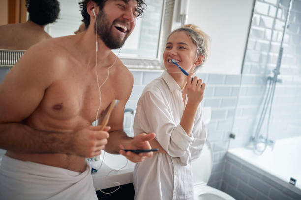 istock Pretty couple brushing teeth together 1300695353