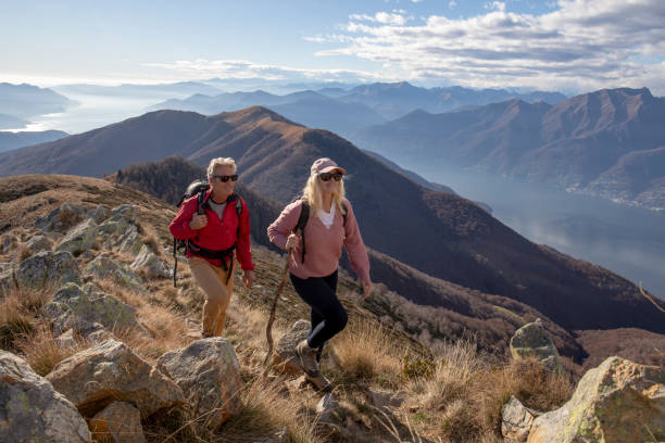 istock Mature couple hike along sunny mountain ridge 1300696057