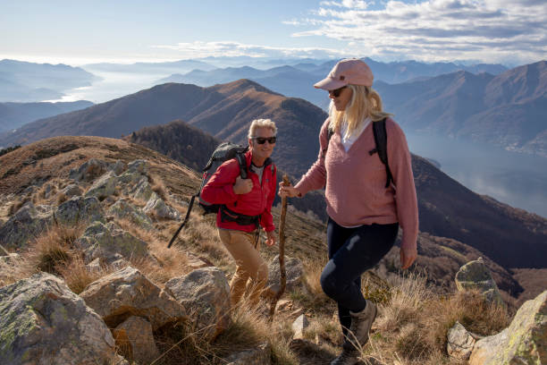 istock Mature couple hike along sunny mountain ridge 1300696063