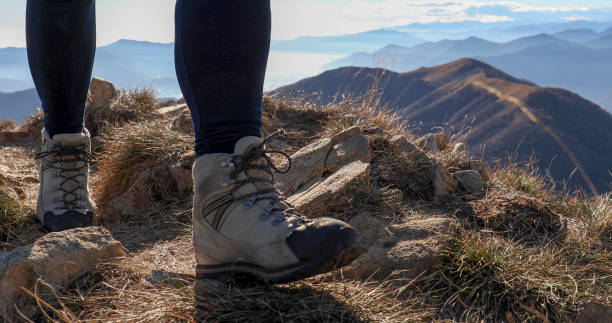 vista de ángulo bajo de las piernas de senderismo en la cresta de la montaña - switzerland hiking boot outdoor pursuit recreational pursuit fotografías e imágenes de stock