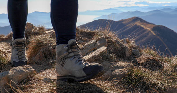 istock Low angle view of hiking legs on mountain ridge 1300696102