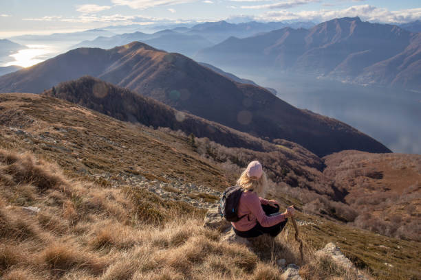 istock Hiker relaxes on sunny mountain ridge 1300696240