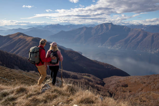 istock Mature couple hike along sunny mountain ridge 1300696371