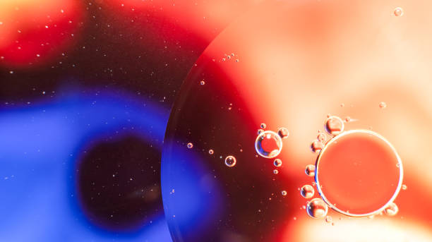 istock Abstract background with colorful oil drops in water. Abstract psychedelic pattern image. Red, purple and scarlet colored abstract pattern. 1300698518