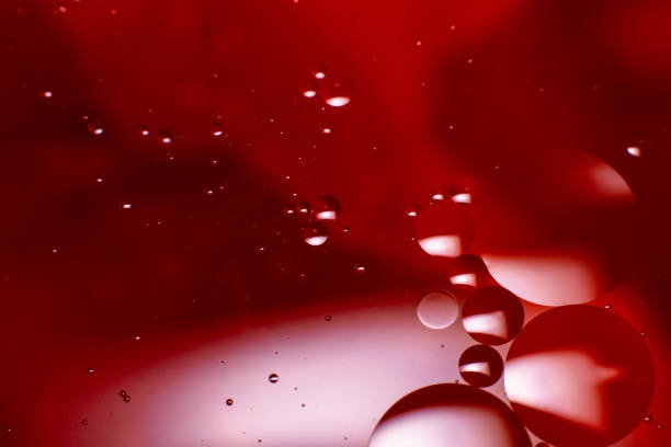 istock Abstract background with colorful oil drops in water. Abstract psychedelic pattern image. Red, purple and scarlet colored abstract pattern. 1300698544