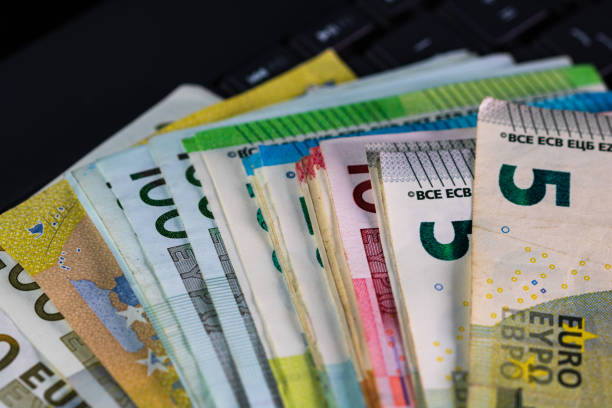 istock Selective focus on stack of EURO money. Euro banknotes isolated. 1300698577