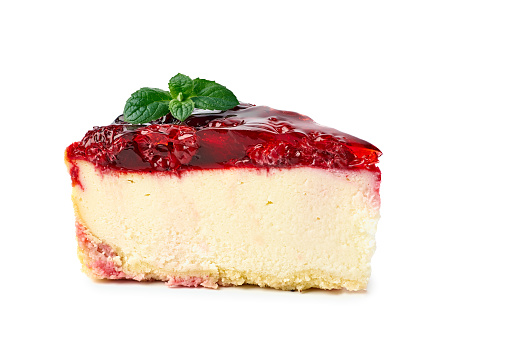 Piece of cheesecake with raspberries topping isolated on white. Clipping path included